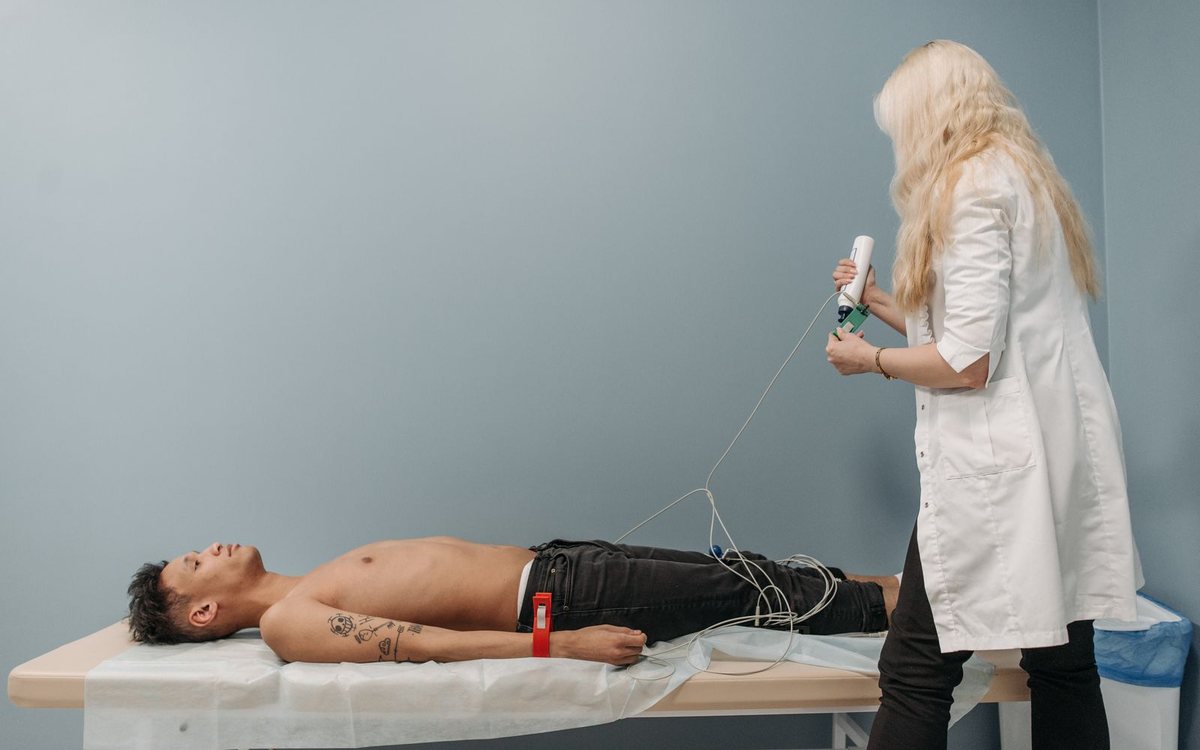 A doctor examining a patient with diagnostic equipment