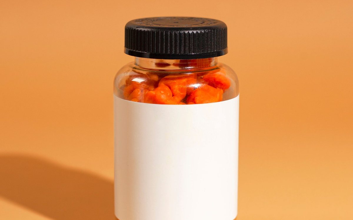 A bottle of orange gummy vitamins