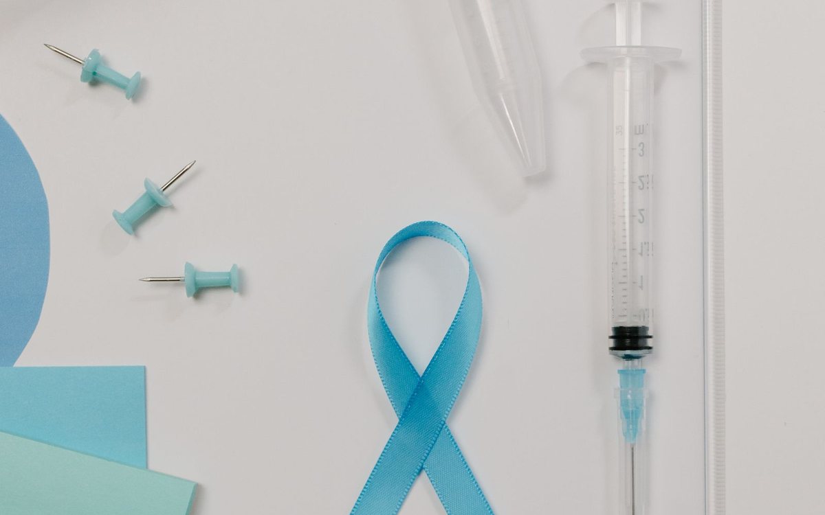 A blue awareness ribbon with medical research supplies