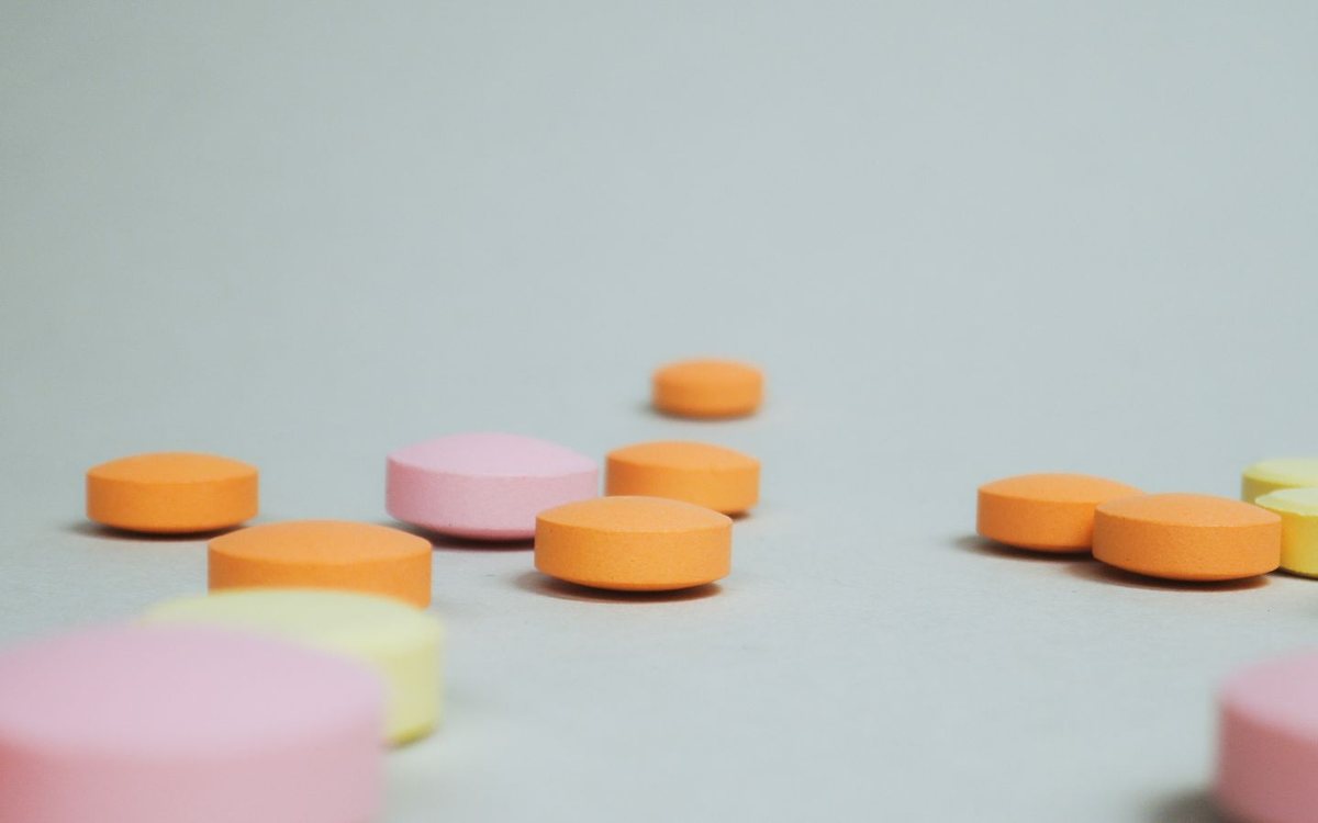 Colorful round tablets on a neutral surface